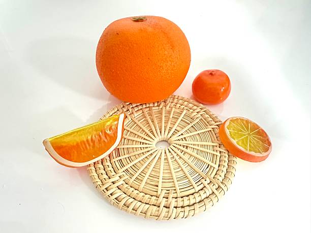 istock Fresh orange fruit with slices and a vibrant background on a round wicker mat showcasing natural colors and textures perfect for healthy living concepts 2246536411
