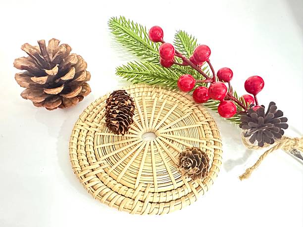 istock Natural Elements on a White Background Including Pine Cones, Red Berries, Greenery, and a Woven Coaster for Seasonal Decoration Ideas 2246536493