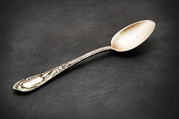 Vintage metal spoon on dark background