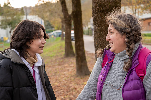 istock Mother and daughter talking in park during autumn 2246539806