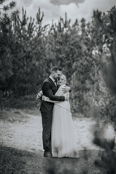 istock Couple embracing in a serene outdoor setting, surrounded by lush greenery, capturing a moment of love and connection in a romantic atmosphere with soft natural light 2246539946