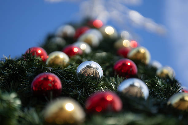 Christmas tree background in bright bokeh. Shiny baubles with bokeh. Decorations Christmas. Colorful baubles with festive bokeh. Christmas background. Winter holiday background
