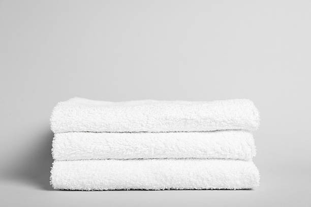 istock Stack of white towels on grey background, closeup. Space for text 2246543066
