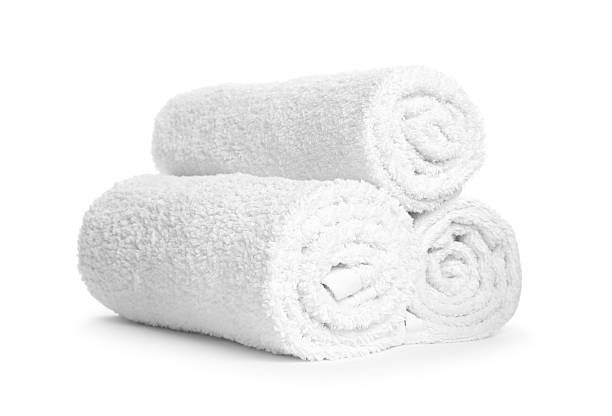 istock Stack of rolled terry towels isolated on white 2246543094