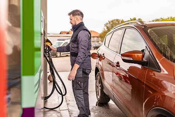 istock Refueling a car at a gas station during daylight with a driver using a fuel pump 2246543532