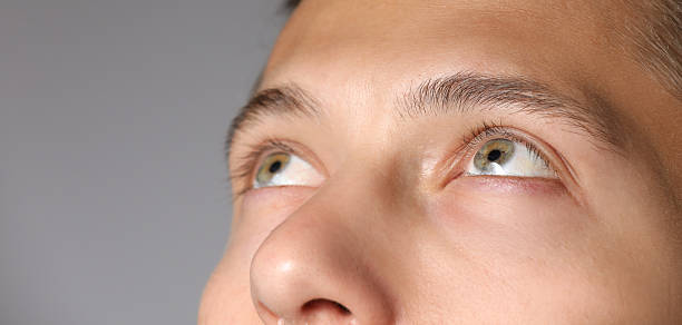 istock Man with beautiful eyes on light grey background, closeup. Space for text 2246544583