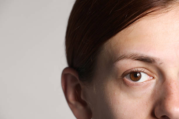 Woman with beautiful eyes on light grey background, closeup. Space for text