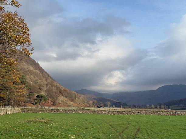 The view across the fields outside of Seathwaite looking towards the hills in the distance in the Lake District