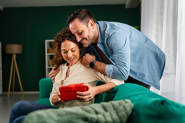istock Couple celebrating anniversary with a special gift 2246545762