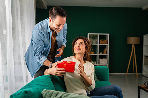 istock Couple celebrating anniversary with a special gift 2246546207