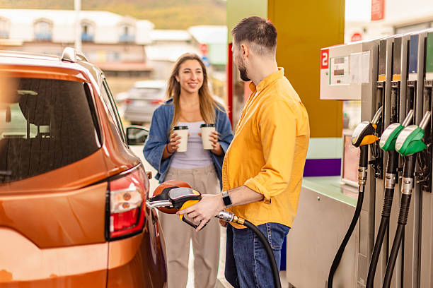 istock Gas station scene featuring a customer and attendant during a busy afternoon refueling session 2246546841