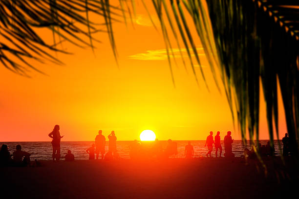 istock People enjoy sandy tropical beach during sunset 2246548966