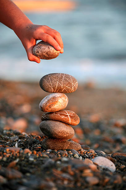 Pebbles stones on seashore as  texture background for design of web banner template page. dry stones illuminated by sun