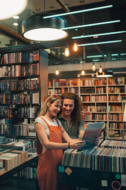 istock Young couple choosing vinyl record in music store 2246553266