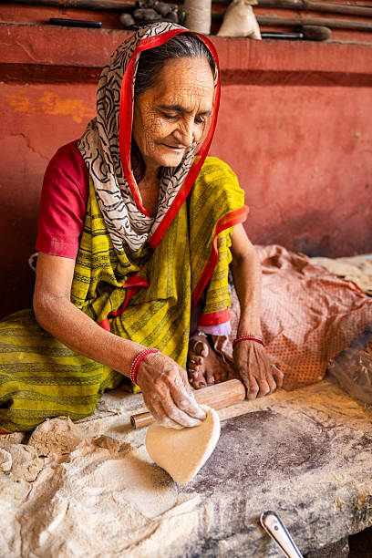 istock Elderly Woman Making Roti — Jaipur, India 2246560040