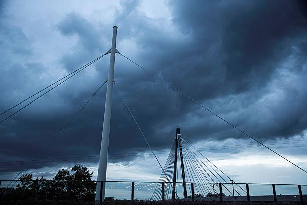 suspension bridge construction and dramatic sky in Vienna