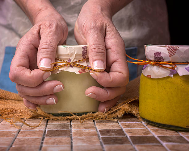 istock hands, senior female, holding a homemade jar 2246563730