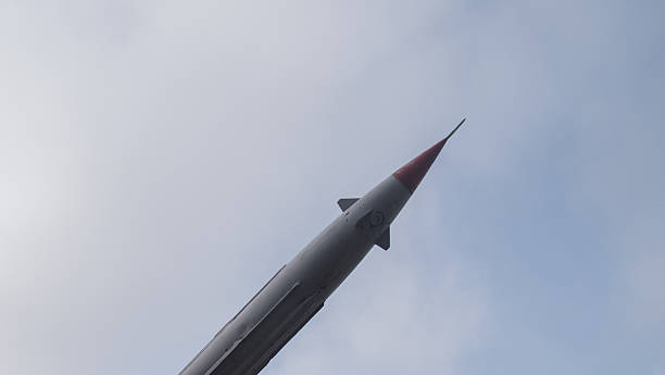 istock rocket tip perspective, detailed view of missile tip with overcast clouds and reflective surface 2246567974