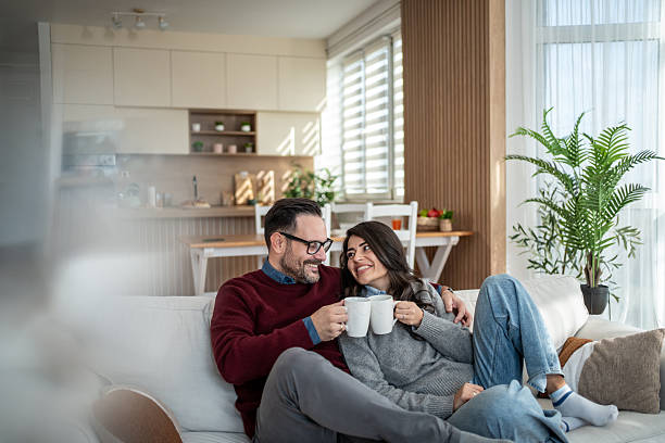 istock Couple enjoying coffee together on sofa at home 2246568144