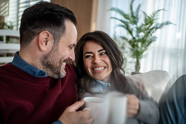 istock Happy couple enjoying coffee and conversation at home 2246568146