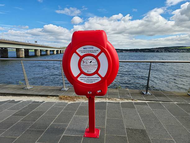 Dundee, Scotland, UK - June 22, 2024: Life-ring, lifebuoy on the promenade. At the background, Tay Road Bridge over River Tay