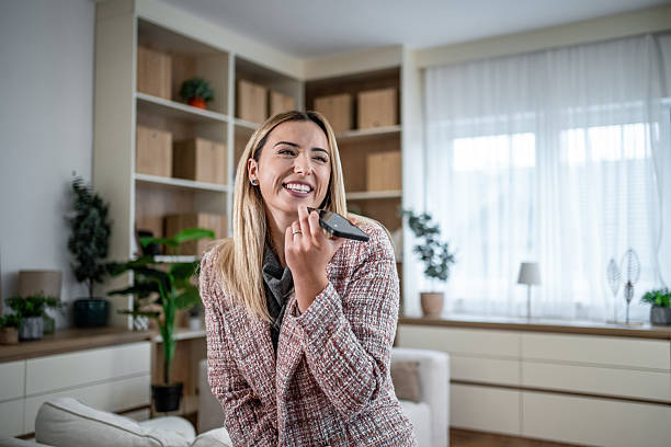 istock Young adult woman using smartphone voice message app 2246569167