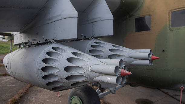 istock closeup of seasoned technician servicing clustered missile tubes on rocket pod with weathered paint 2246572597