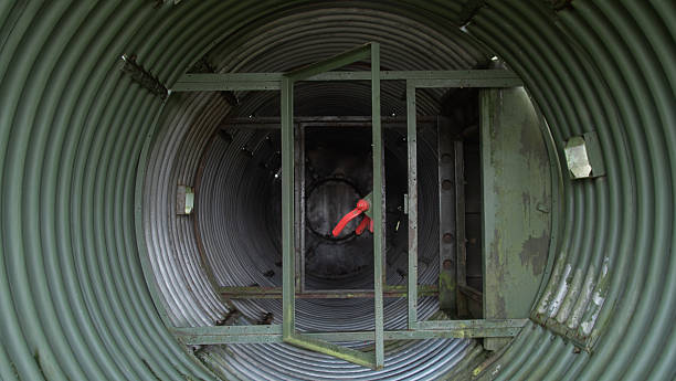 istock skilled technician performing safety check amidst deteriorated urban industrial piping and supports 2246573066
