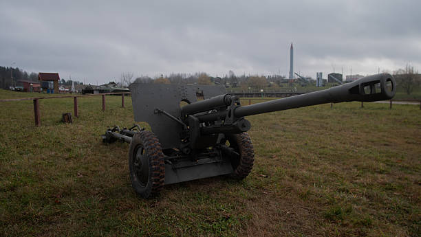 istock rusty battlefield relic, decommissioned weapon positioned on damp earth with industrial skyline nearby 2246573888