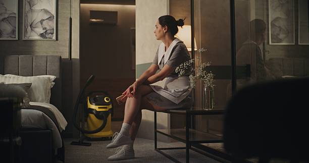 istock Tired Housekeeping Worker Pauses to Breathe After Cleaning 2246573985