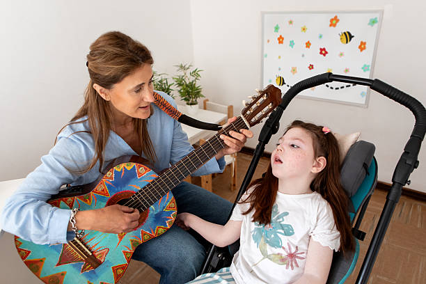 istock Girl with cerebral palsy during her music therapy session 2246575509