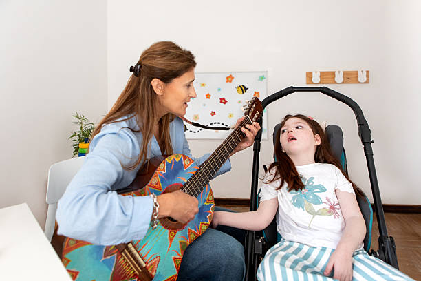 istock Girl with cerebral palsy during her music therapy session 2246575513