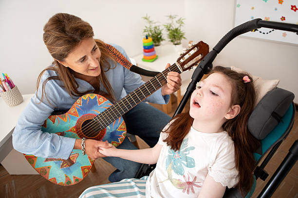 istock Girl with cerebral palsy during her music therapy session 2246575632