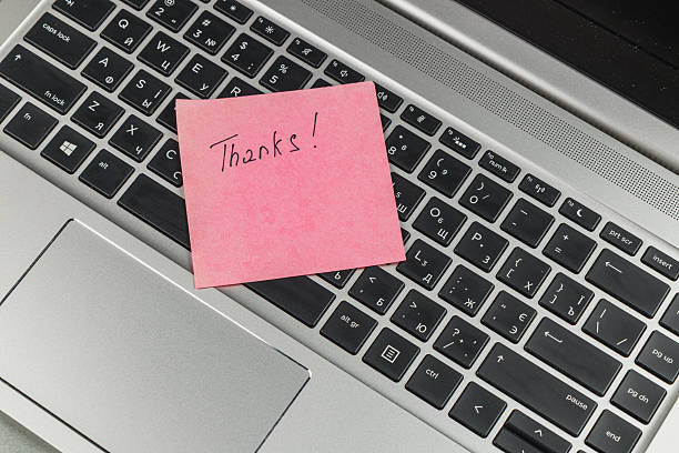 istock Thank you note placed on a laptop keyboard in a home office setup 2246578565
