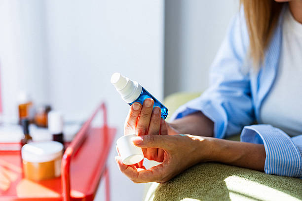 istock Person Applying Skincare Serum From Blue Spray Bottle During Relaxed Morning Routine 2246578792
