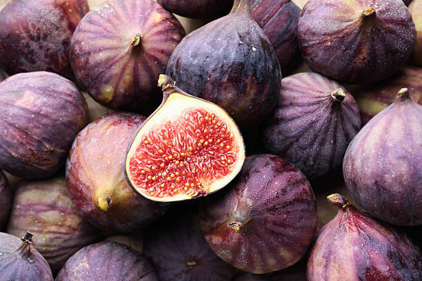istock Whole and cut figs as background, top view 2246581528