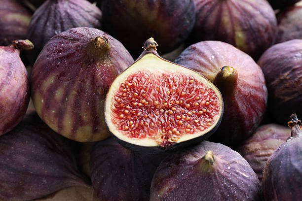 istock Whole and cut figs as background, top view 2246581596