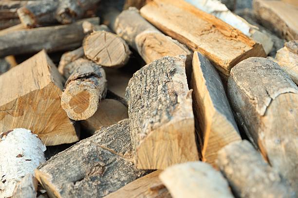 istock Pile of cut firewood outdoors, closeup view 2246583207