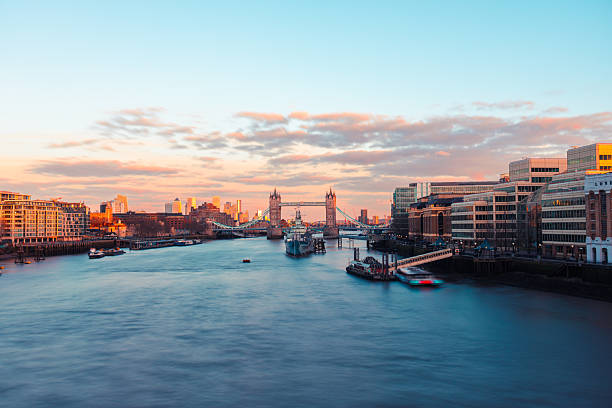 Iconic tower bridge spanning the river thames with a vibrant cityscape at sunset