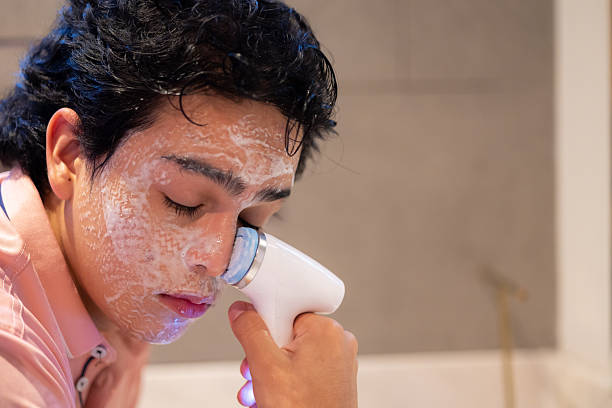 istock Man applying skincare 2246585822