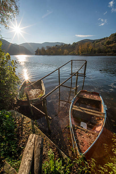 Abandoned boats on a dilapidated pier in autumn