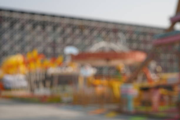 Motion blur photograph of a spinning carousel at a Christmas market, creating warm light trails and festive atmosphere