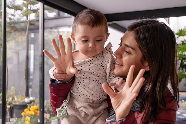 istock mother playing and spending time with her baby while carrying her in her arms 2246595030