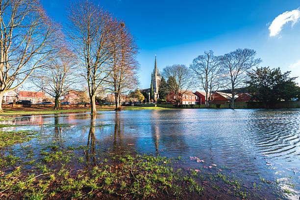 istock Marlow All Saints Church reflected in flood water amongst trees 2246600692