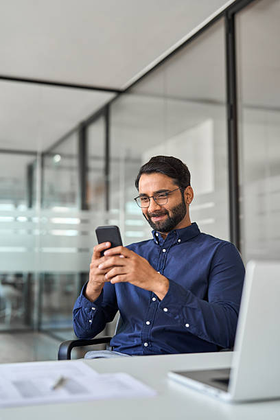 istock Professional Indian business man working using smartphone in office. Vertical 2246601203