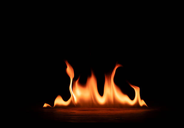 istock Bonfire flames burning on iron floor isolated on black background 2246602672
