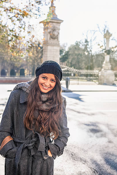 istock Young woman smiling while enjoying autumn city park 2246606165
