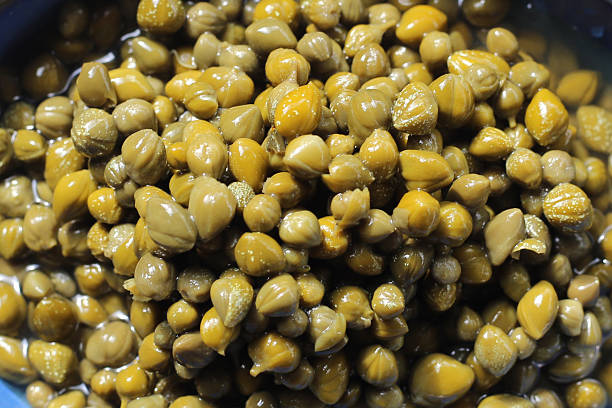 istock Capers in brine, small pickled flower buds 2246607672