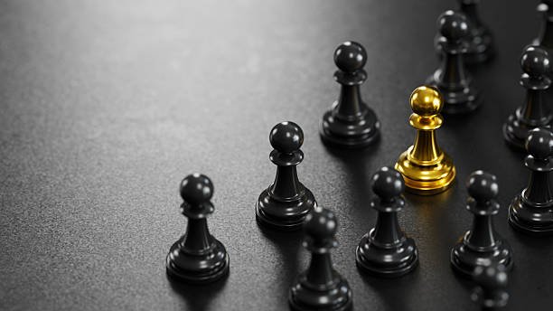 istock Standing Out: The Golden Pawn in a Black Chess Landscape 2246609961