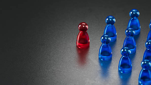 istock Red Transparent Game Chess Standing Distinctly Among Blue Chess on Dark Background 2246609979